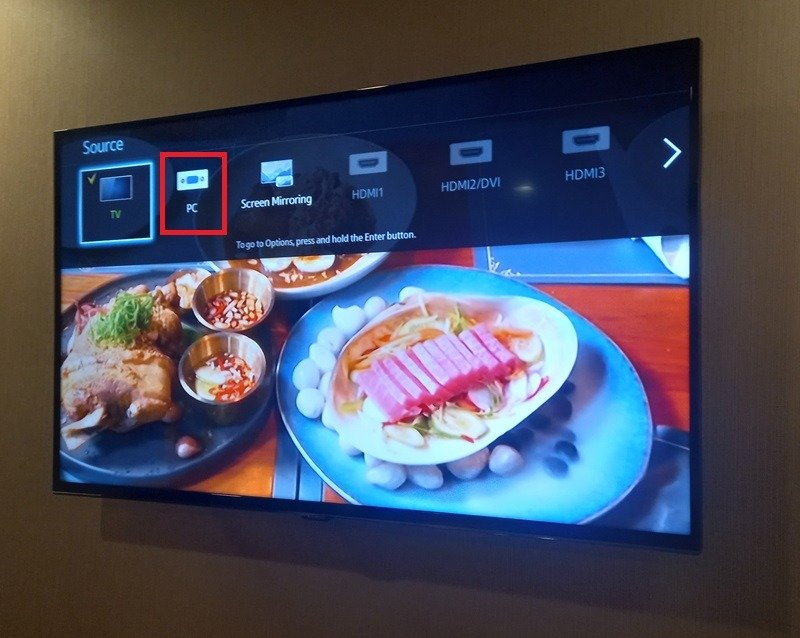 Multiple input sources displayed on a TV, including TV, AV, HDMI, etc. Change TV Source to "PC" mode.